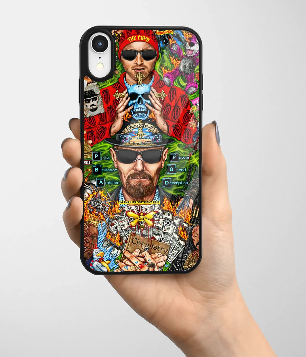 A hand holding a glass phone case with a colorful design.