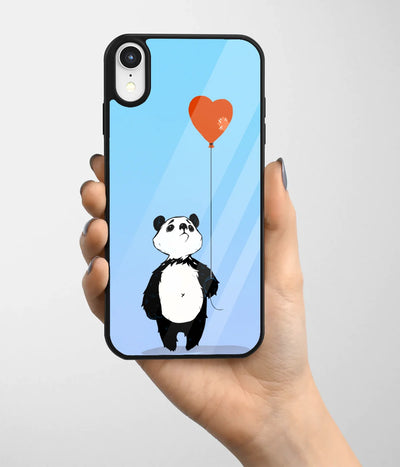 A hand holding a glass phone case with a colorful design.