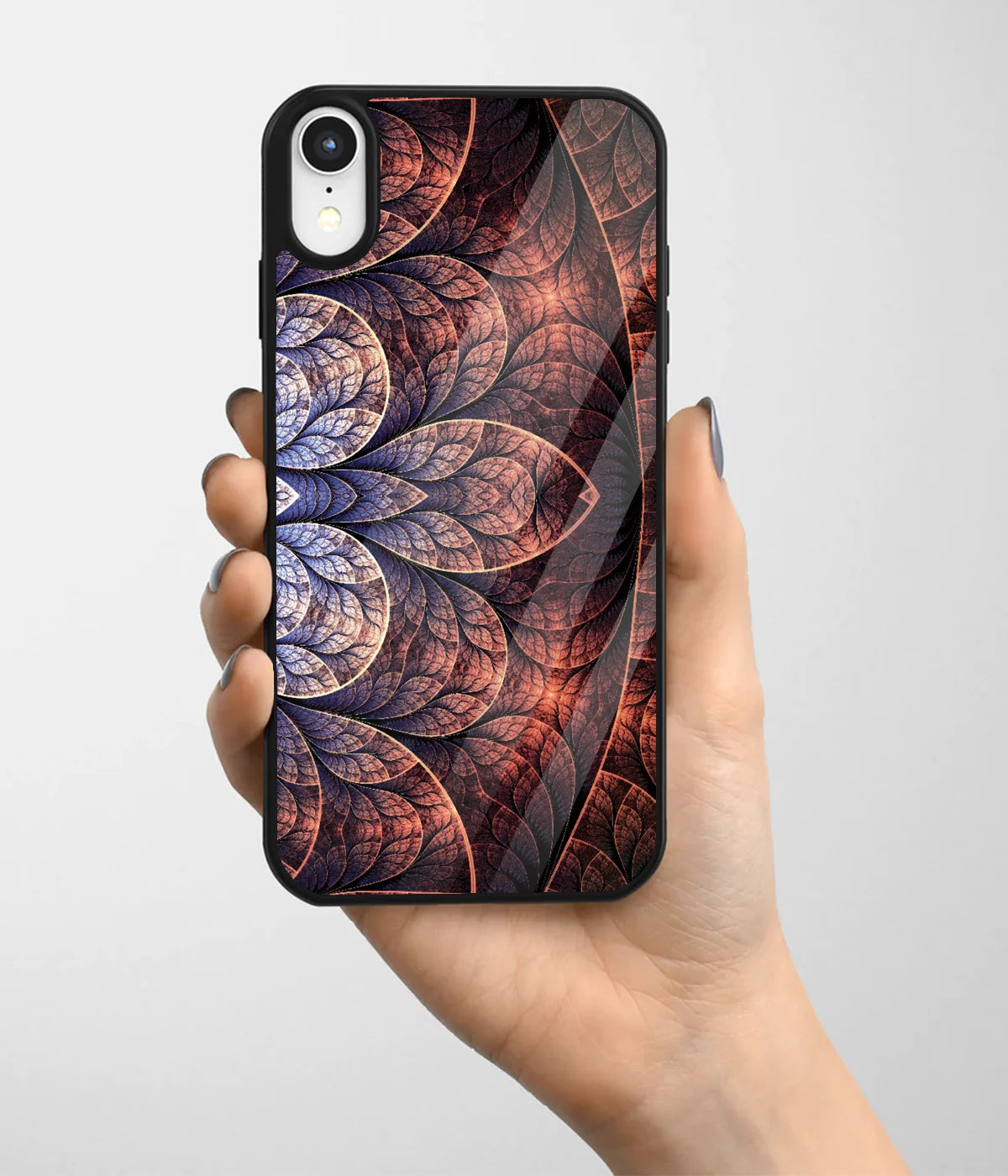 A hand holding a glass phone case with a colorful design.