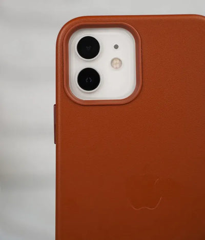 Close-up shot of the premium brown leather case for iPhone detailing raised protective lip around the iPhone camera module.