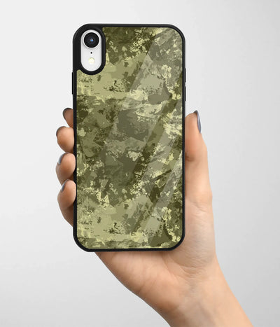 A hand holding a glass phone case with a colorful design.