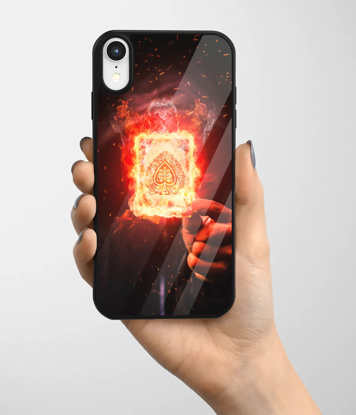 A hand holding a glass phone case with a colorful design.