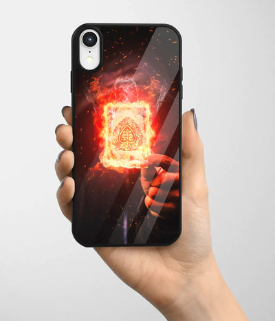A hand holding a glass phone case with a colorful design.