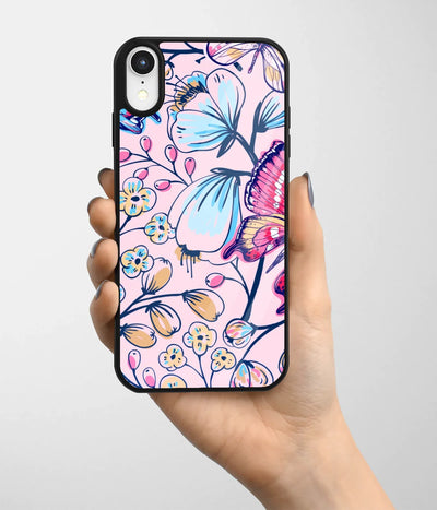 A hand holding a glass phone case with a colorful design.