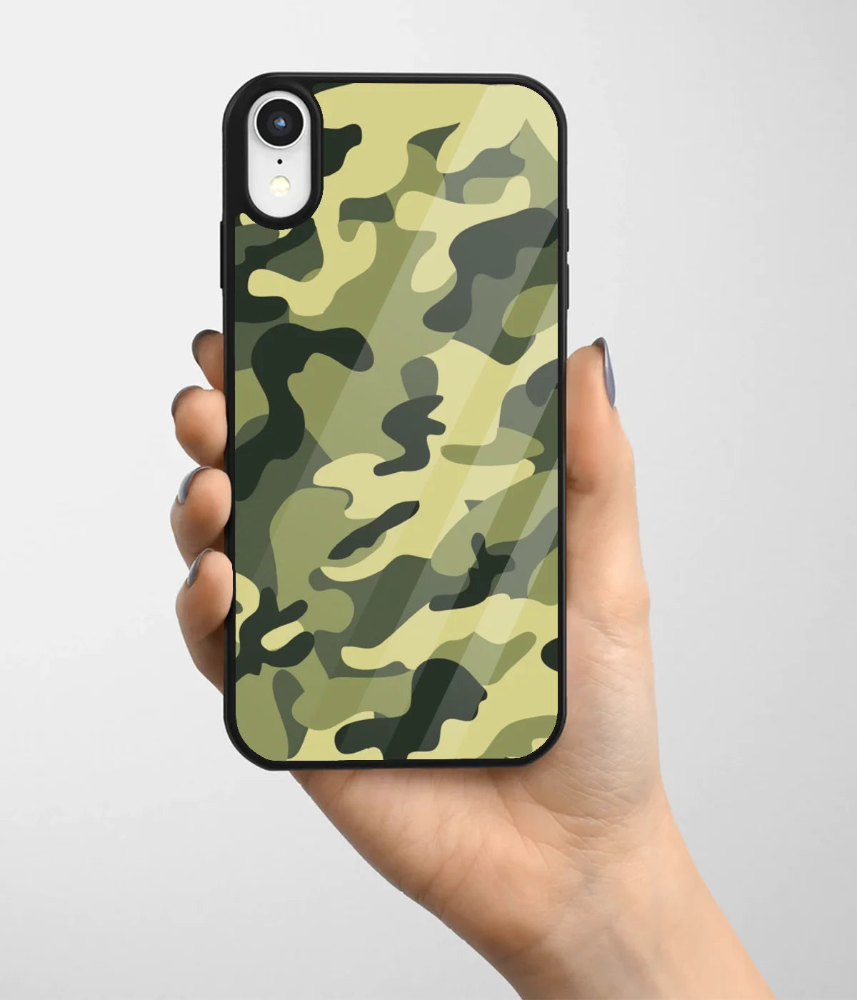 A hand holding a glass phone case with a colorful design.