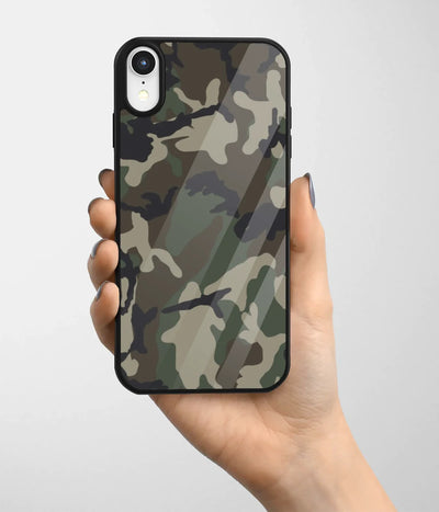 A hand holding a glass phone case with a colorful design.