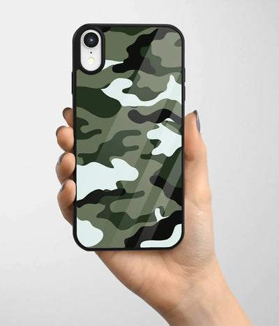 A hand holding a glass phone case with a colorful design.