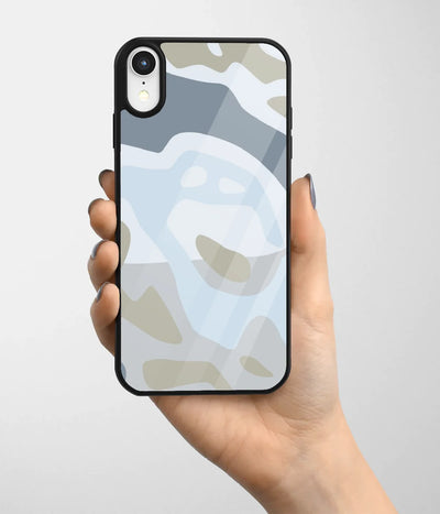 A hand holding a glass phone case with a colorful design.