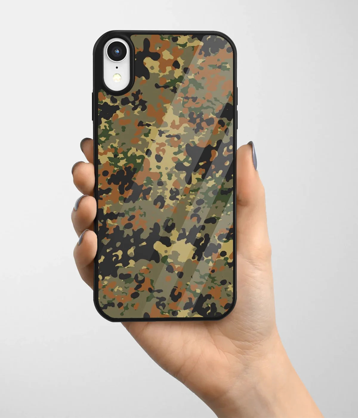 A hand holding a glass phone case with a colorful design.