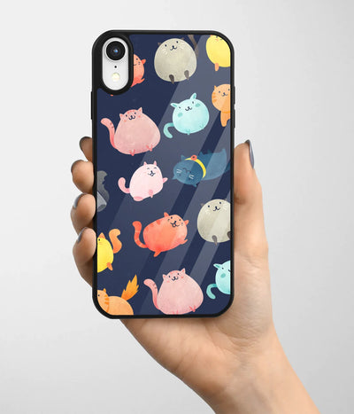 A hand holding a glass phone case with a colorful design.