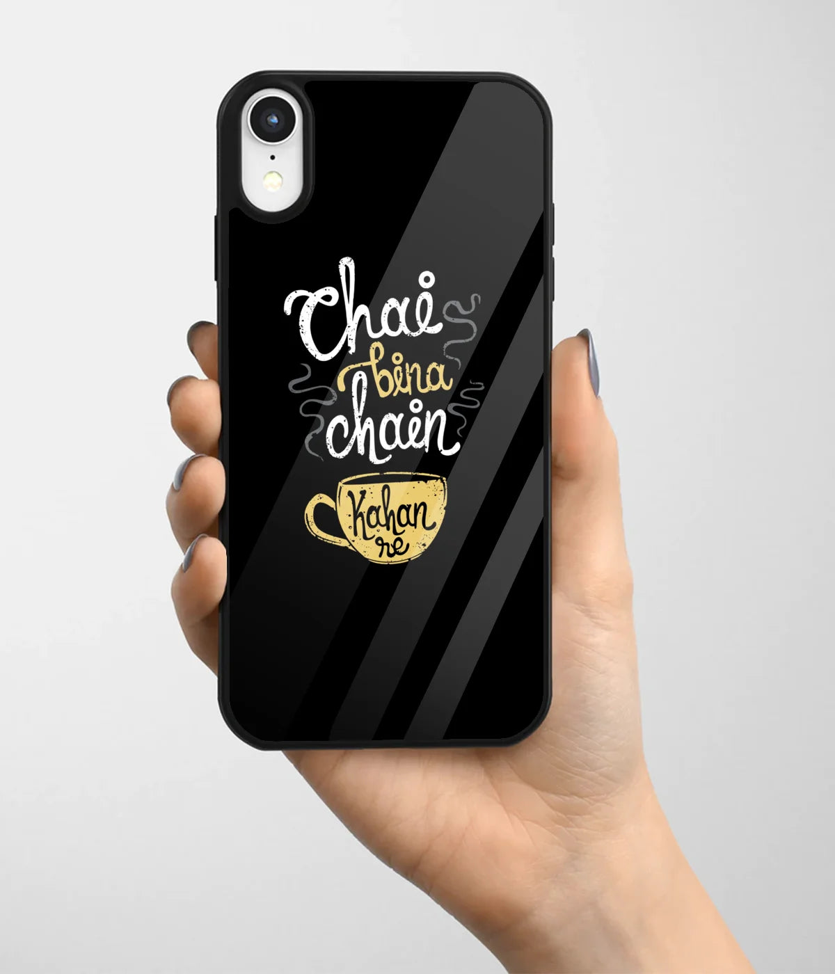 A hand holding a glass phone case with a colorful design.