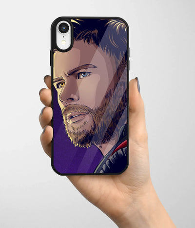A hand holding a glass phone case with a colorful design.