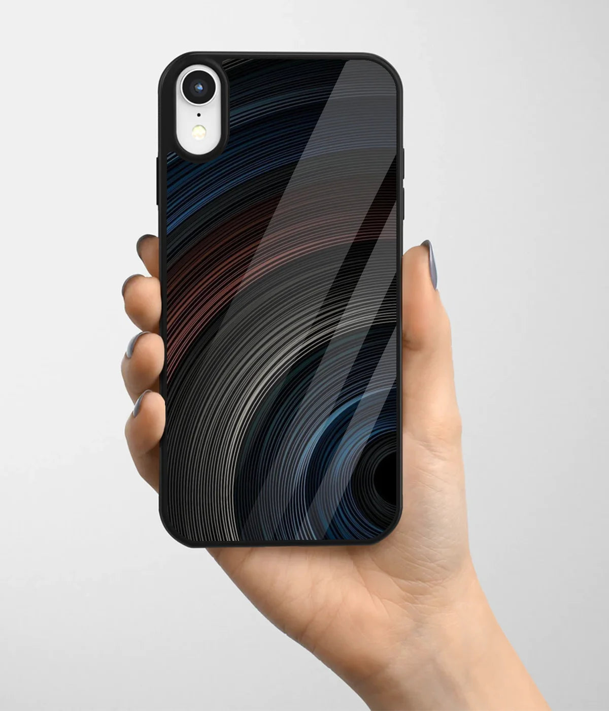 A hand holding a glass phone case with a colorful design.