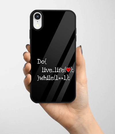 A hand holding a glass phone case with a colorful design.