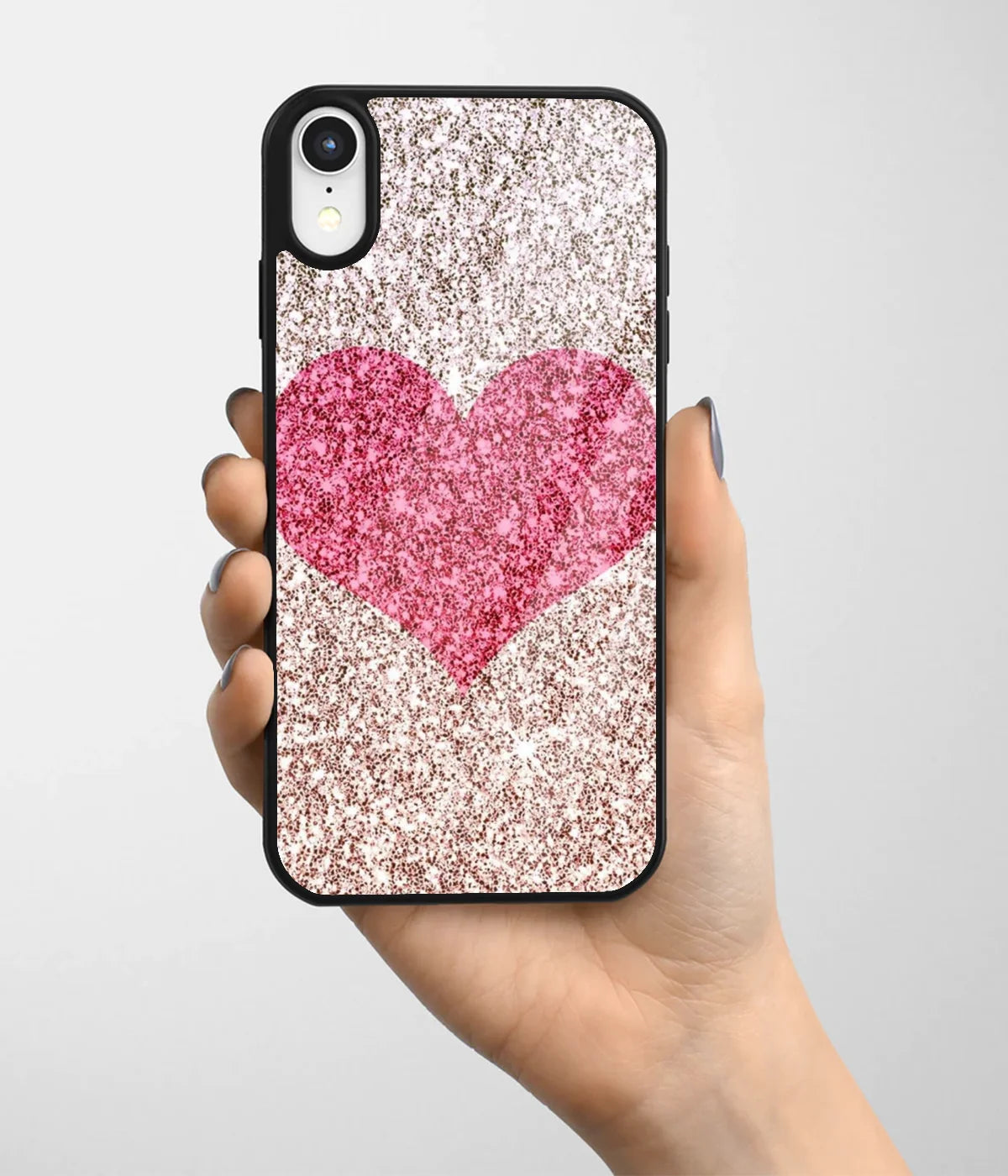 A hand holding a glass phone case with a colorful design.