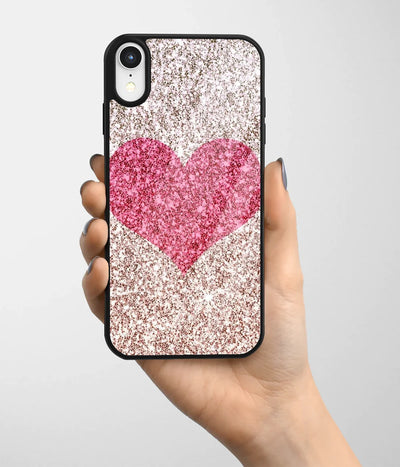 A hand holding a glass phone case with a colorful design.