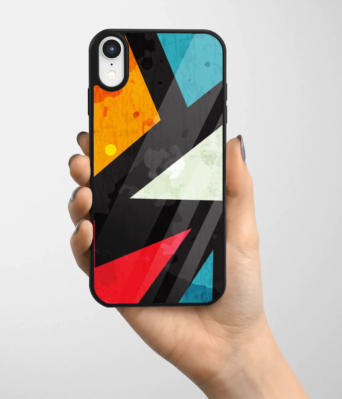 A hand holding a glass phone case with a colorful design.