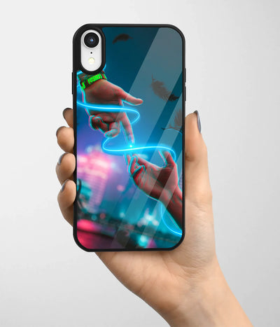 A hand holding a glass phone case with a colorful design.
