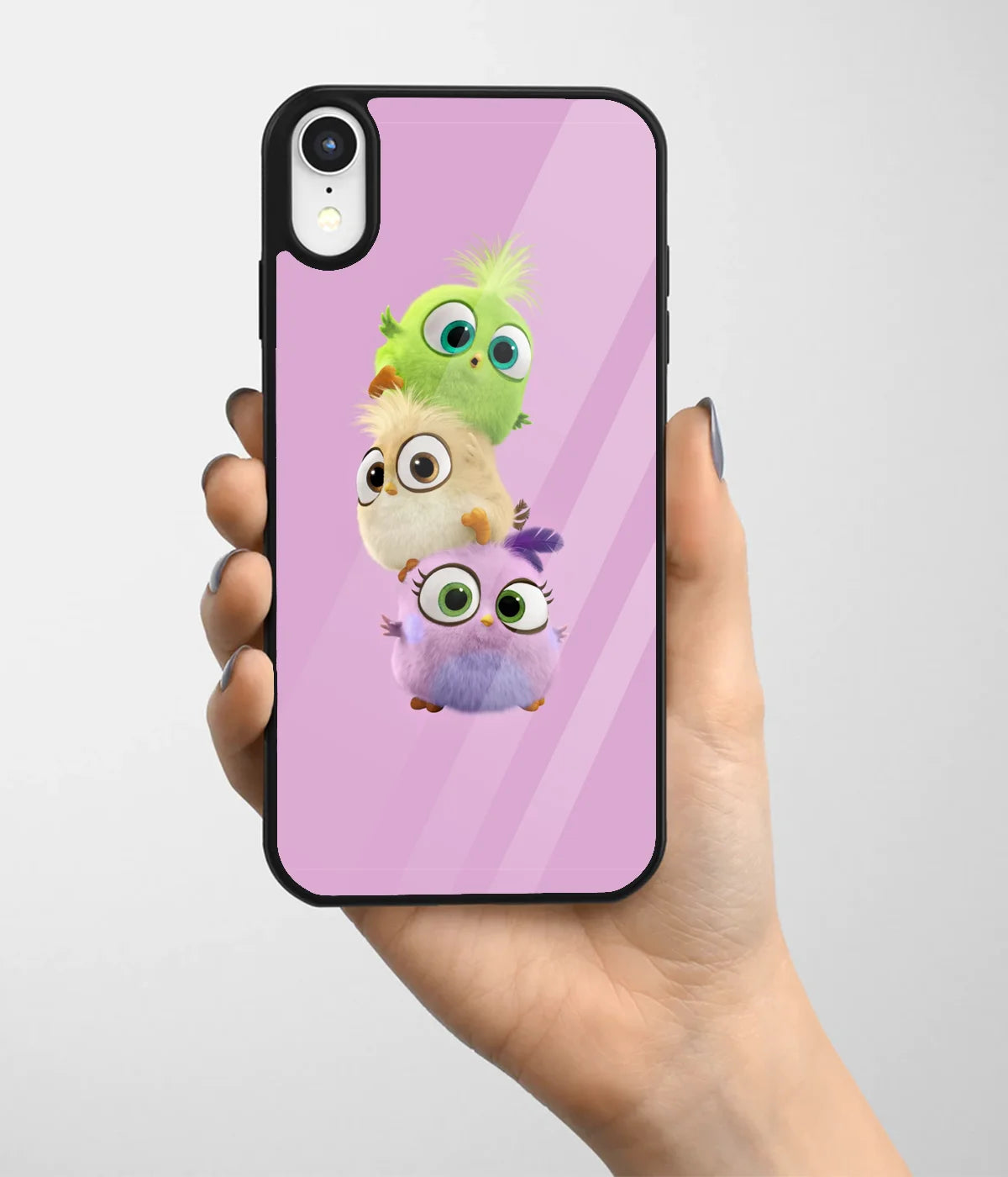 A hand holding a glass phone case with a colorful design.