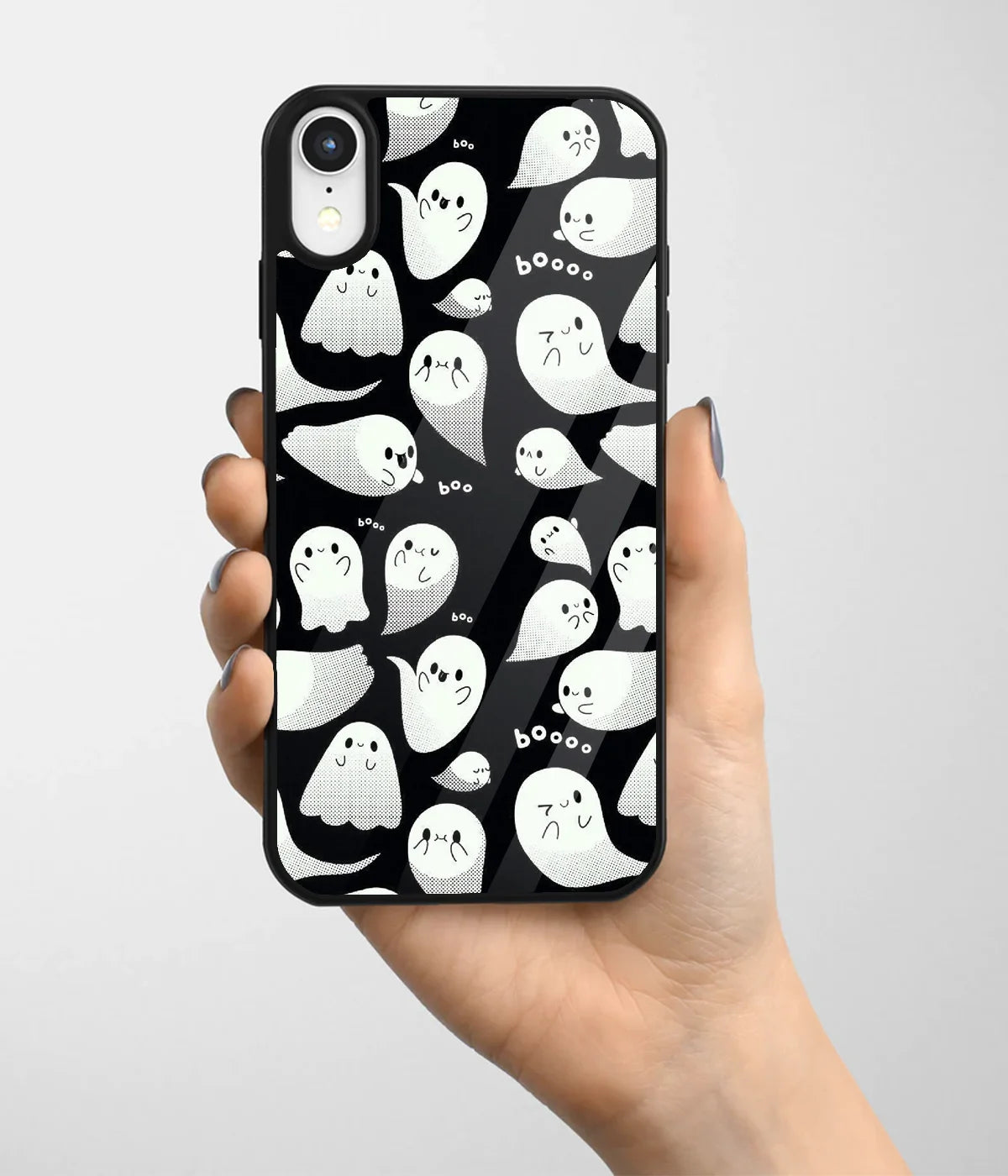 A hand holding a glass phone case with a colorful design.