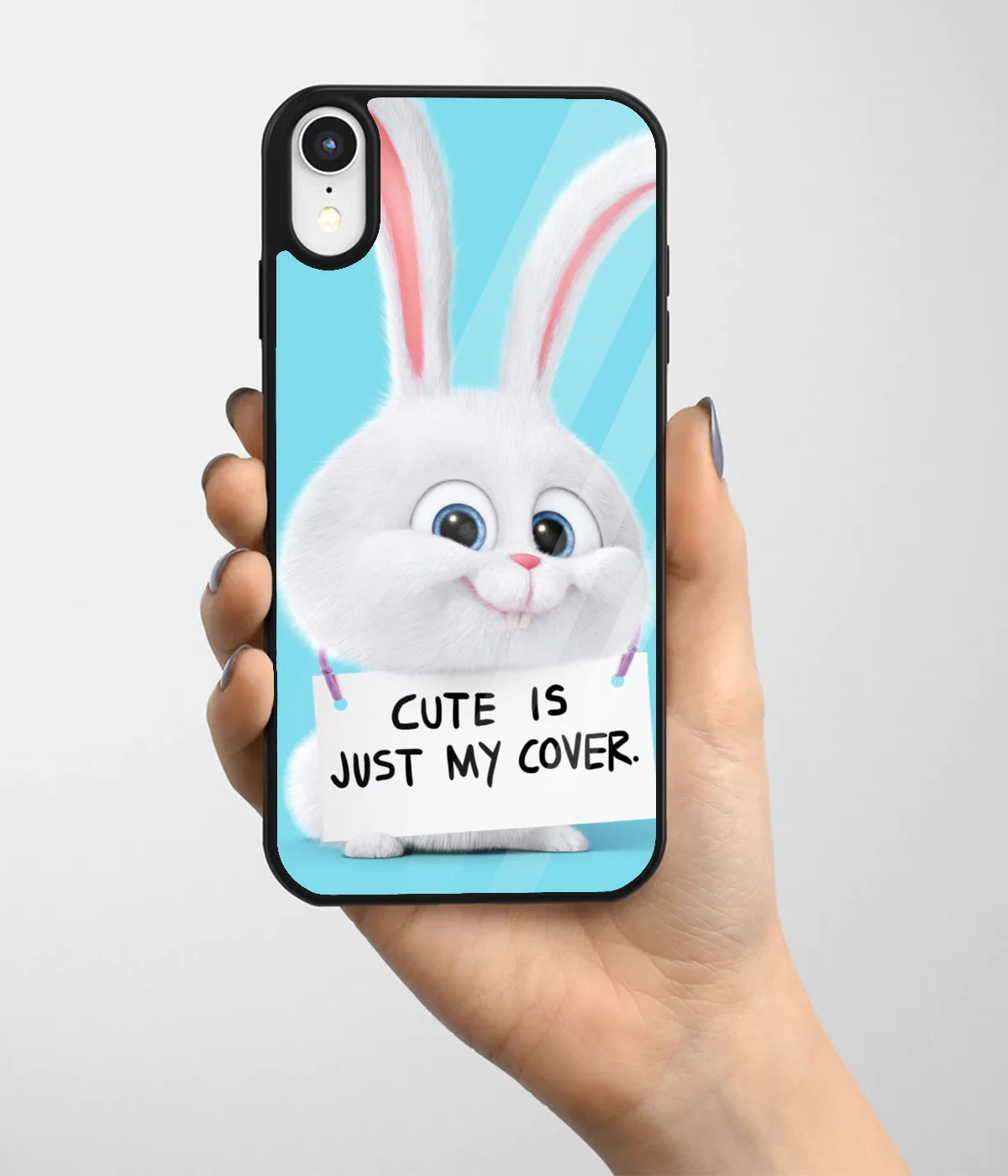 A hand holding a glass phone case with a colorful design.