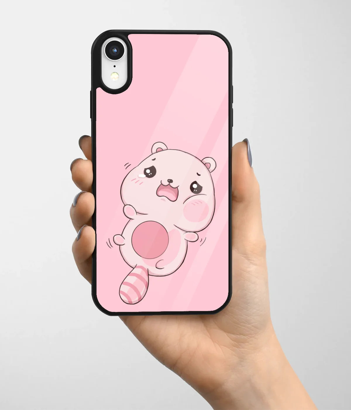 A hand holding a glass phone case with a colorful design.