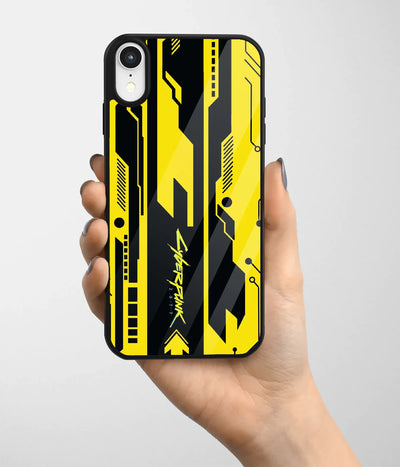 A hand holding a glass phone case with a colorful design.