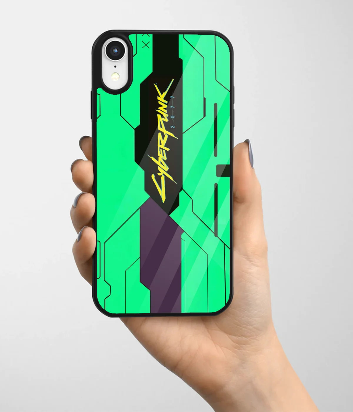 A hand holding a glass phone case with a colorful design.
