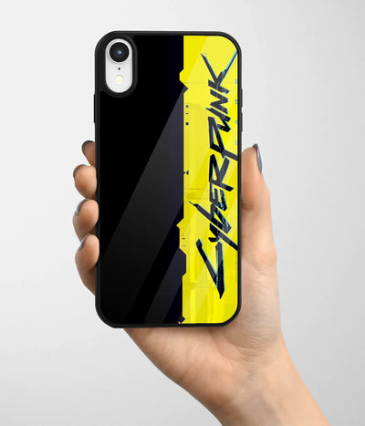 A hand holding a glass phone case with a colorful design.