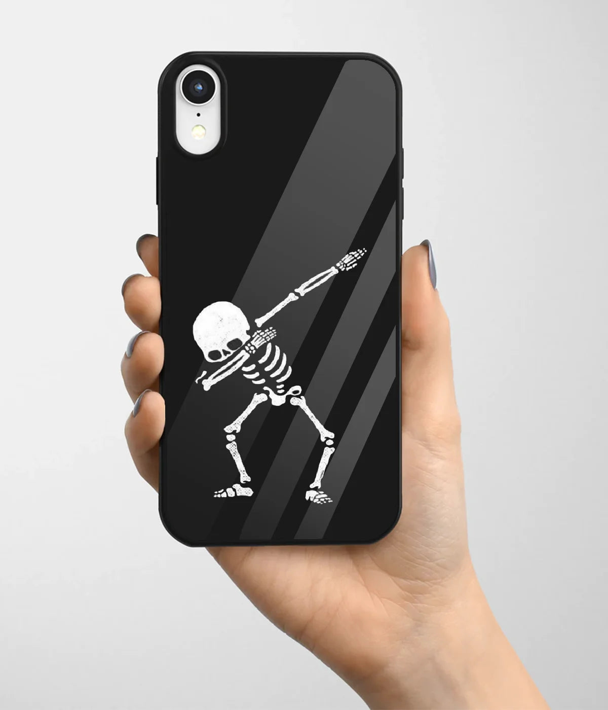 A hand holding a glass phone case with a colorful design.