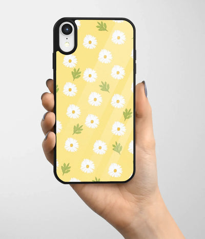 A hand holding a glass phone case with a colorful design.