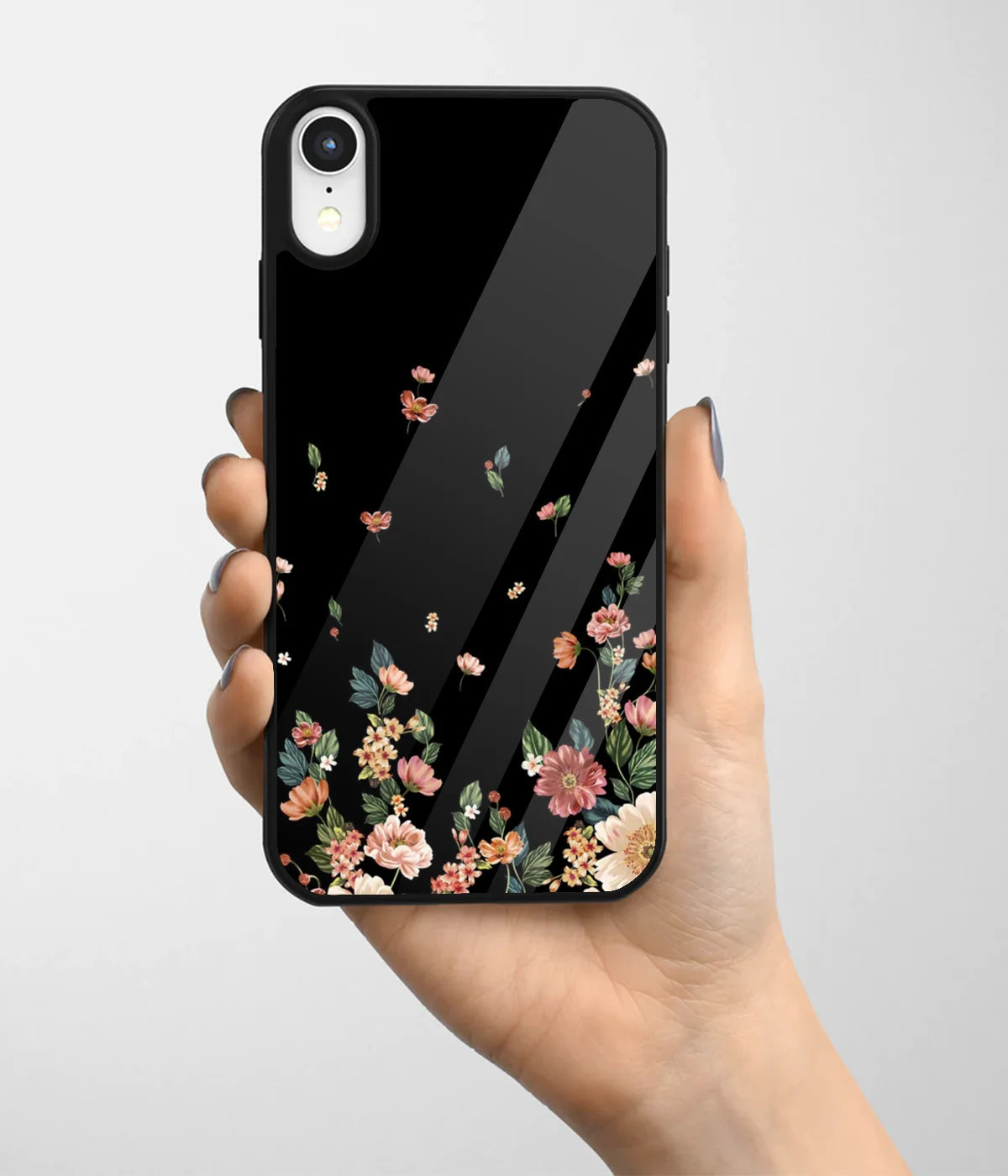 A hand holding a glass phone case with a colorful design.