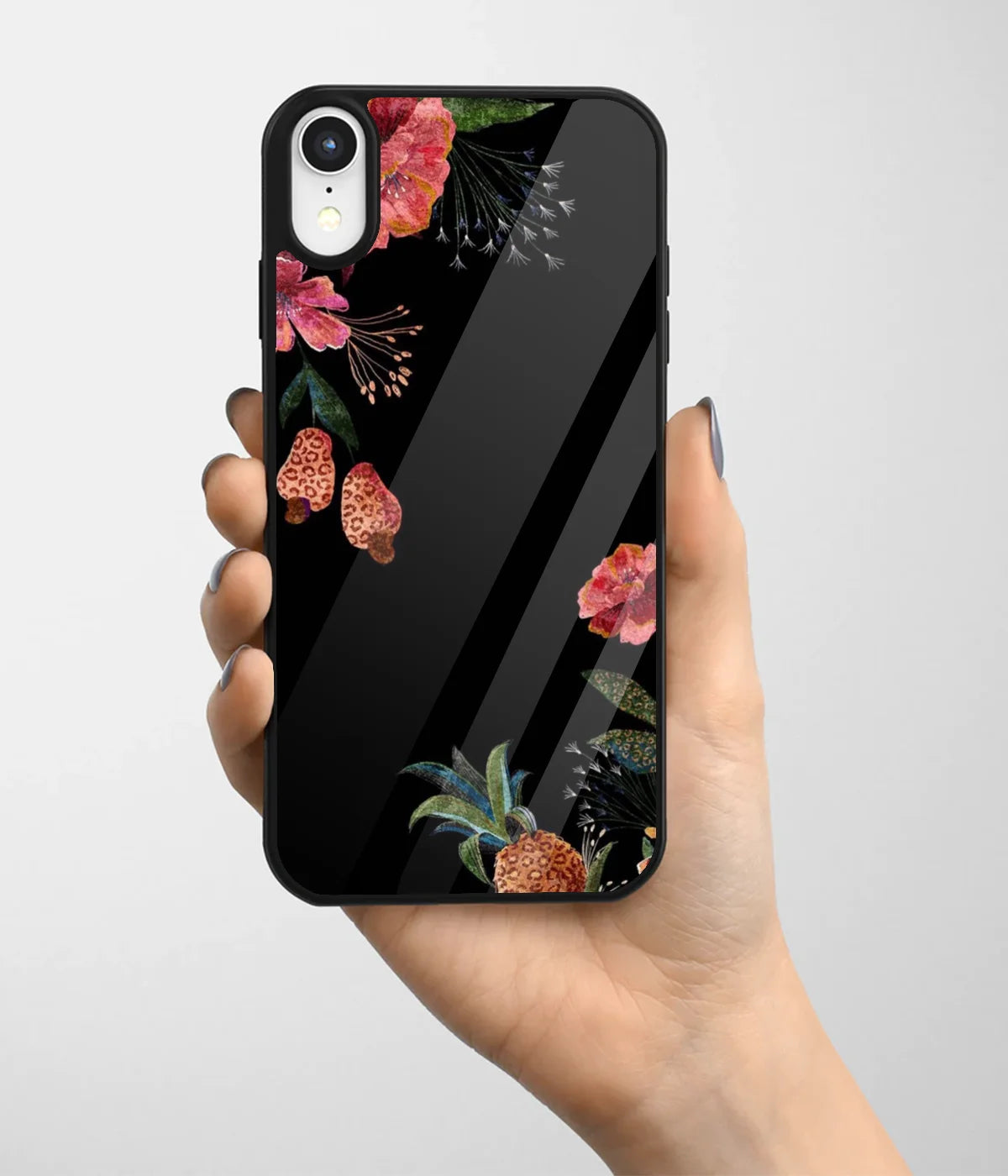 A hand holding a glass phone case with a colorful design.