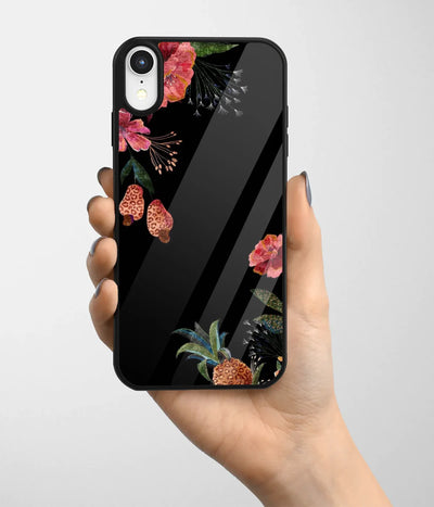 A hand holding a glass phone case with a colorful design.