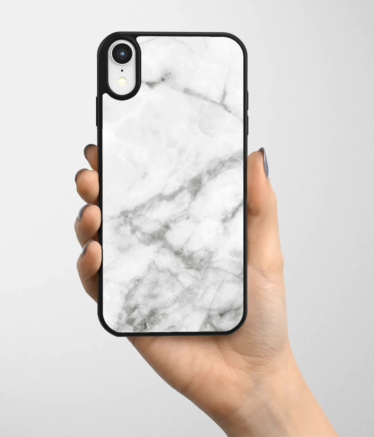 A hand holding a glass phone case with a colorful design.