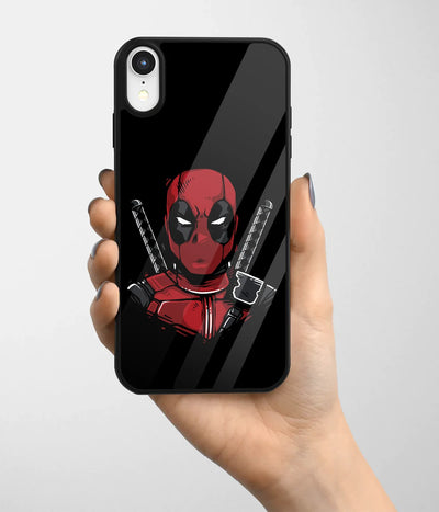 A hand holding a glass phone case with a colorful design.