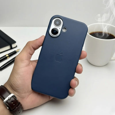 Hand holding a deep navy blue leather MagSafe case for iPhone.