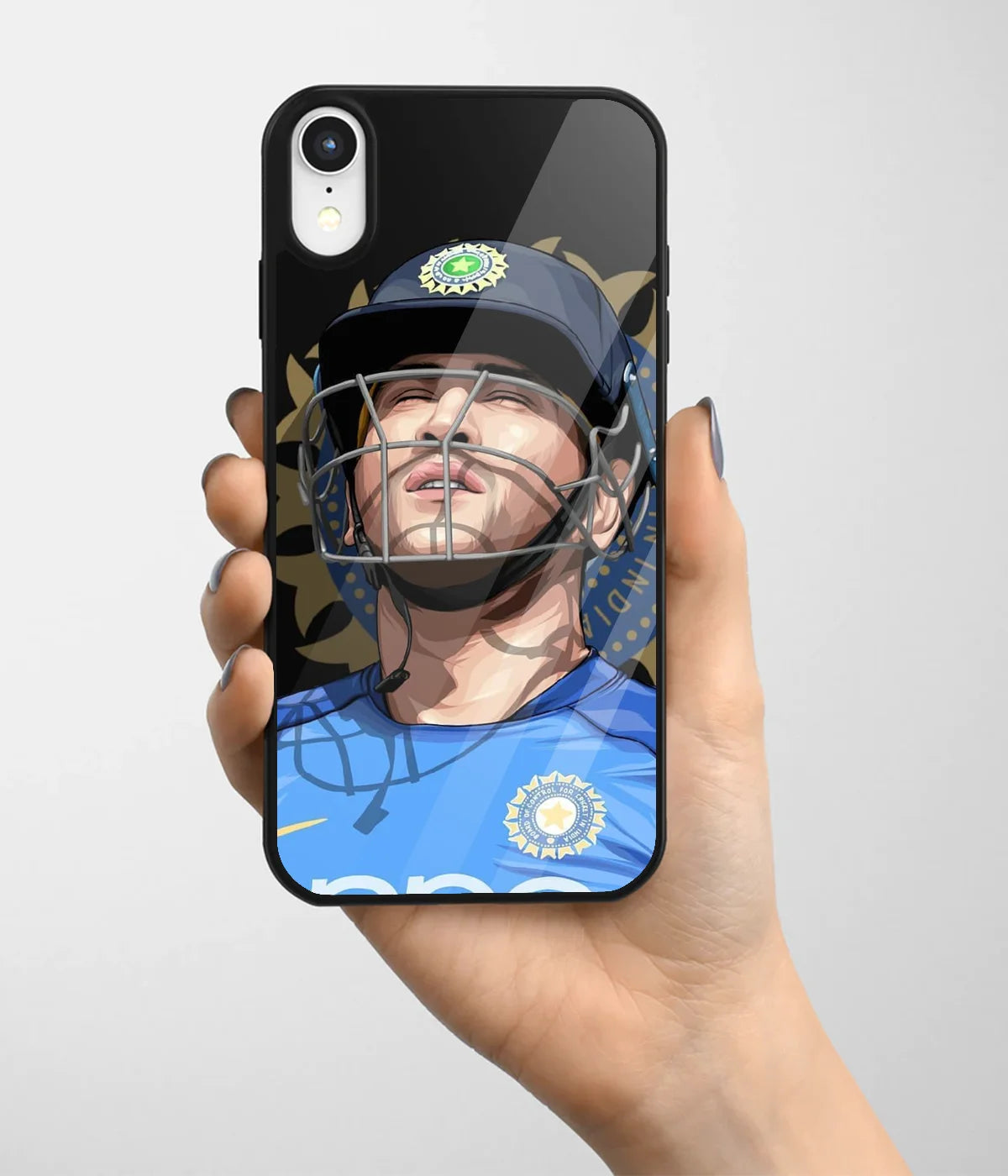 A hand holding a glass phone case with a colorful design.