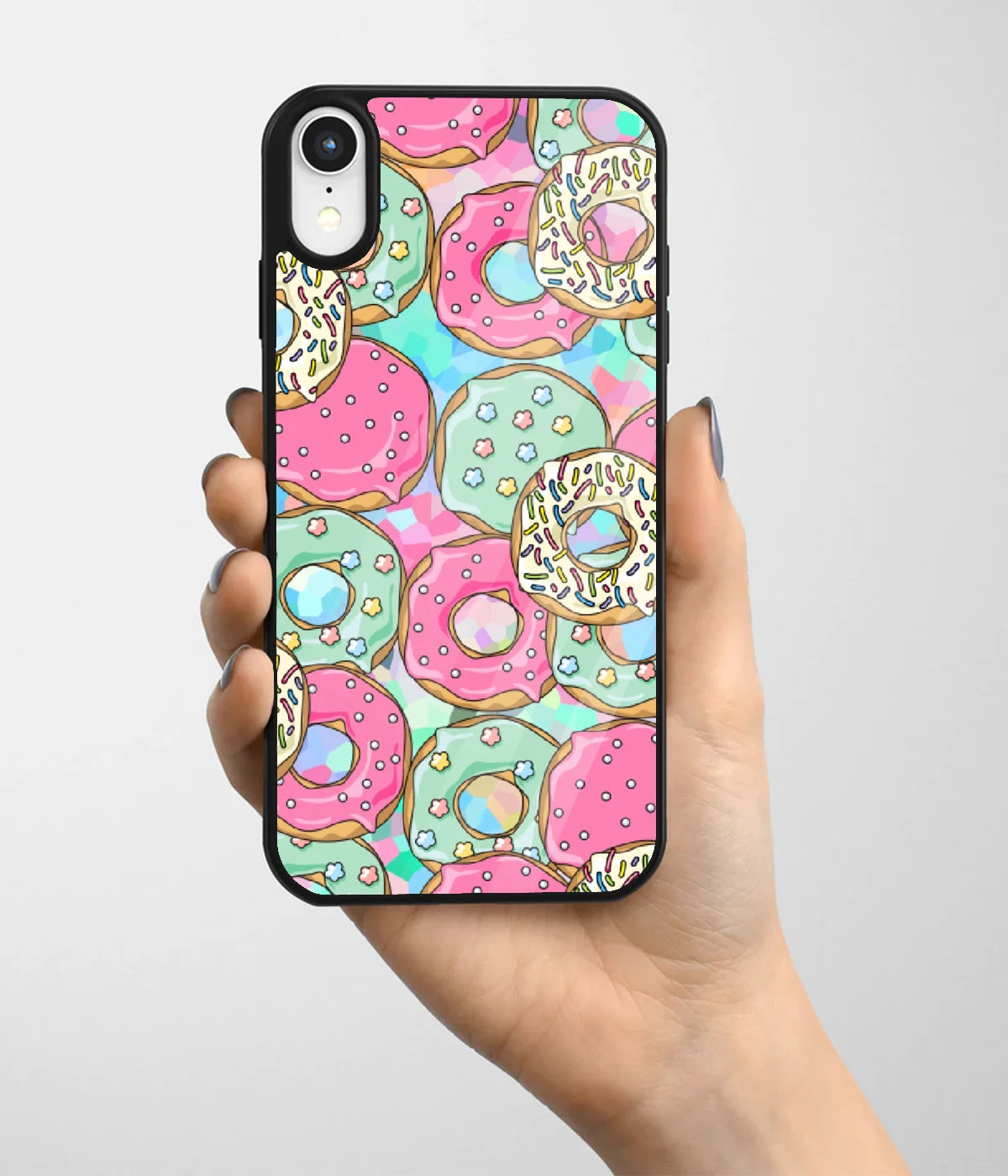 A hand holding a glass phone case with a colorful design.