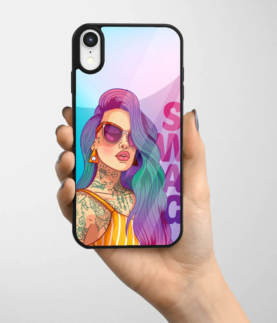 A hand holding a glass phone case with a colorful design.