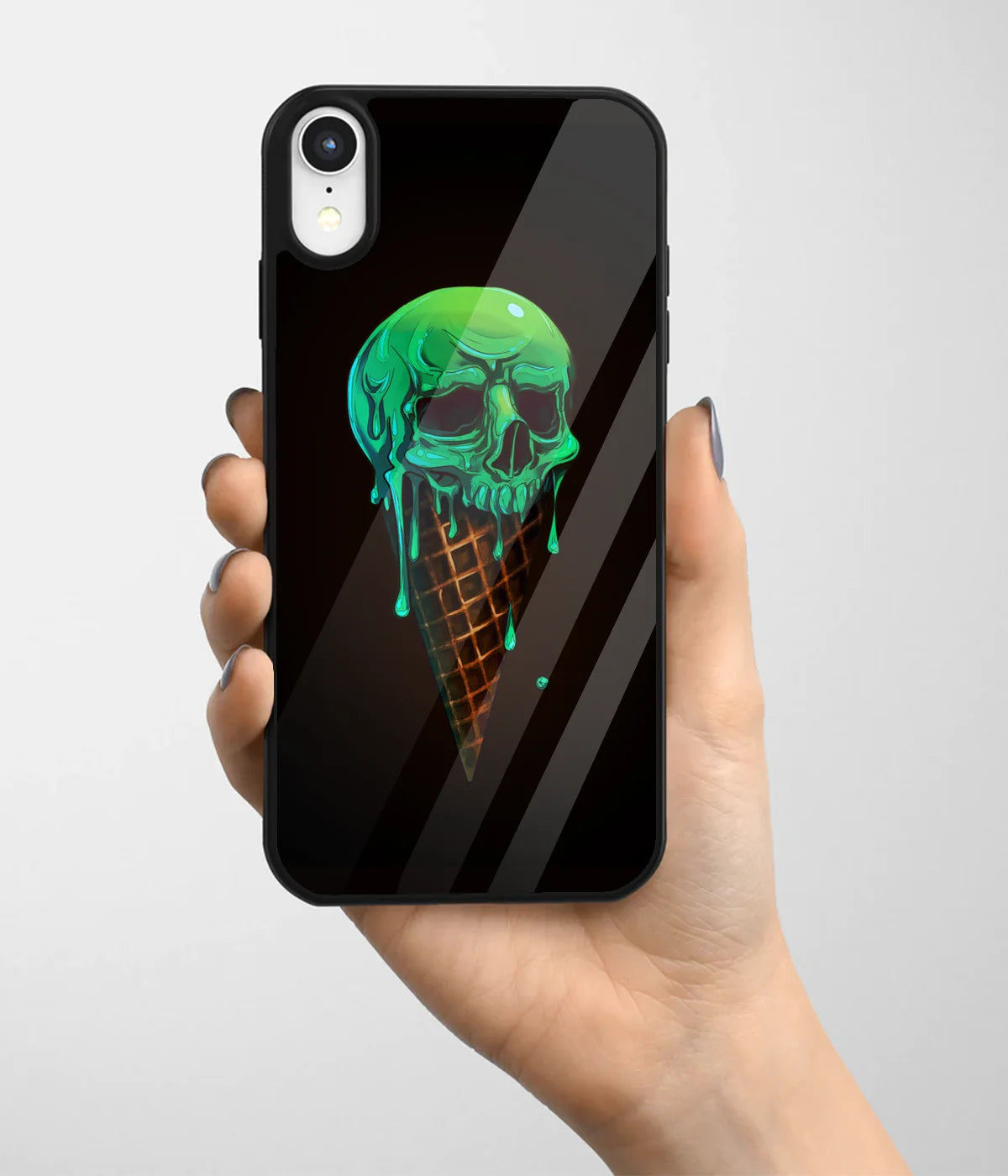 A hand holding a glass phone case with a colorful design.
