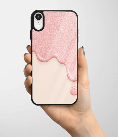 A hand holding a glass phone case with a colorful design.