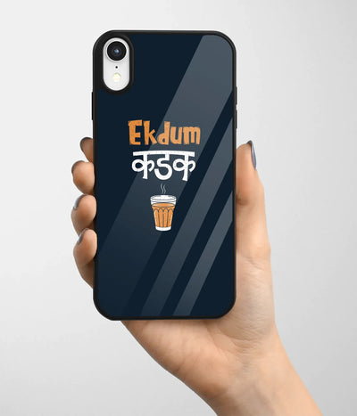A hand holding a glass phone case with a colorful design.