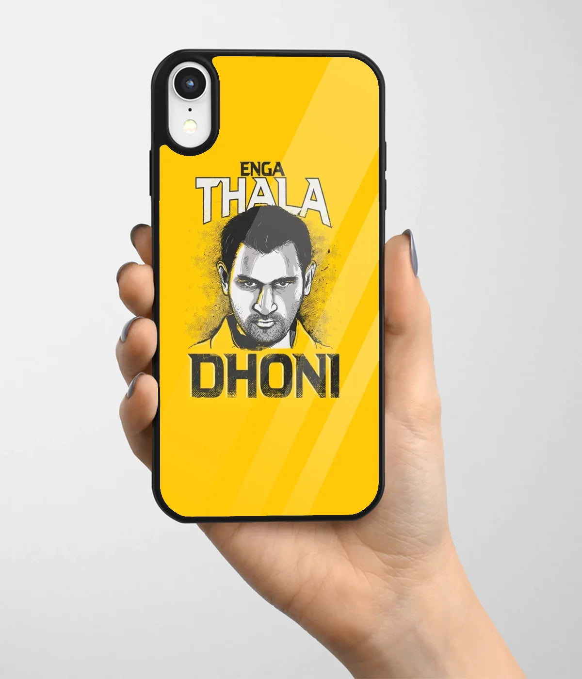 A hand holding a glass phone case with a colorful design.