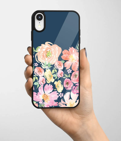 A hand holding a glass phone case with a colorful design.