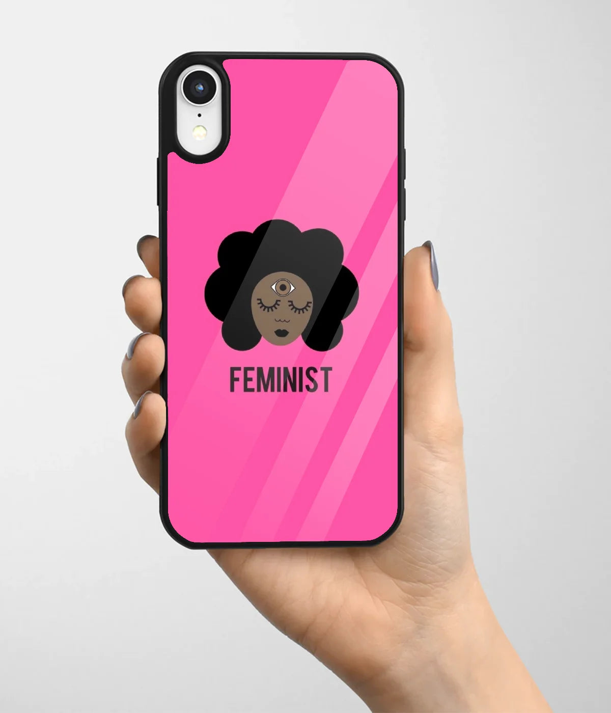 A hand holding a glass phone case with a colorful design.