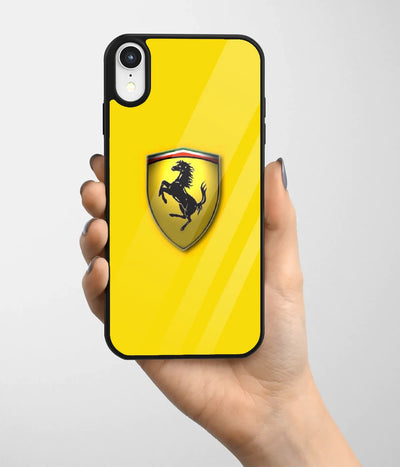 A hand holding a glass phone case with a colorful design.