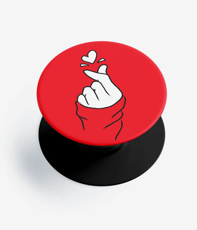 A top-down view of a phone grip holder on a clean white background