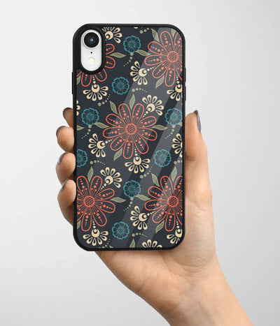 A hand holding a glass phone case with a colorful design.
