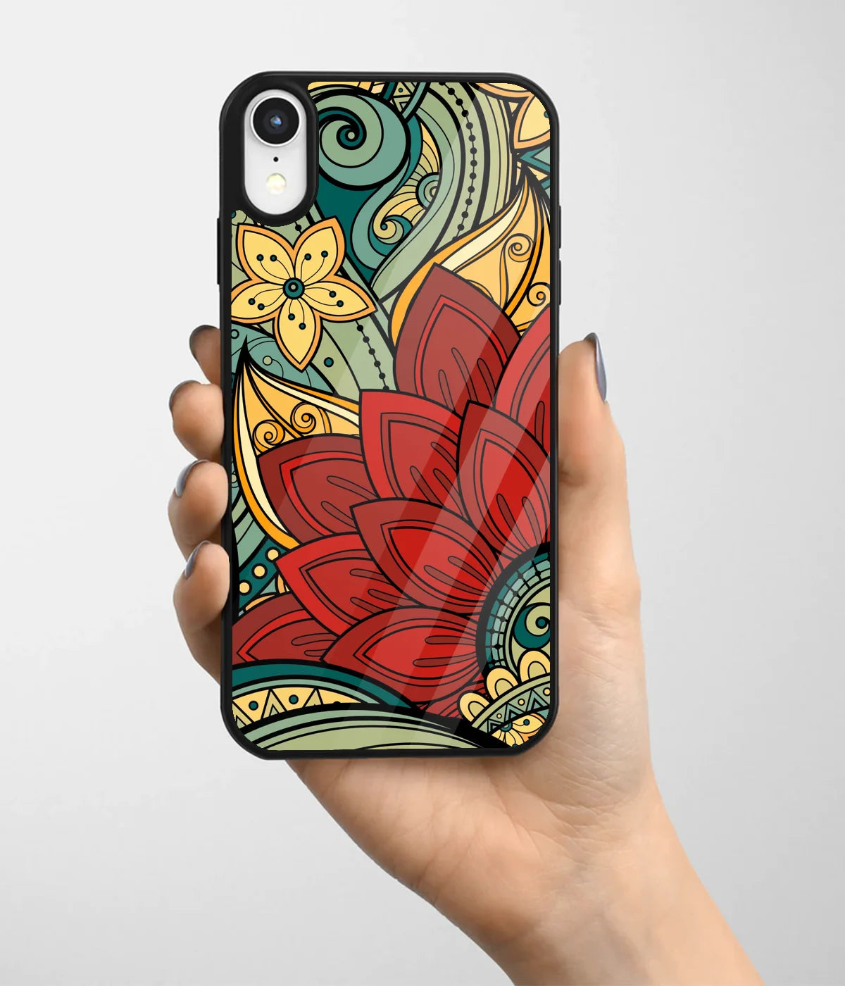 A hand holding a glass phone case with a colorful design.